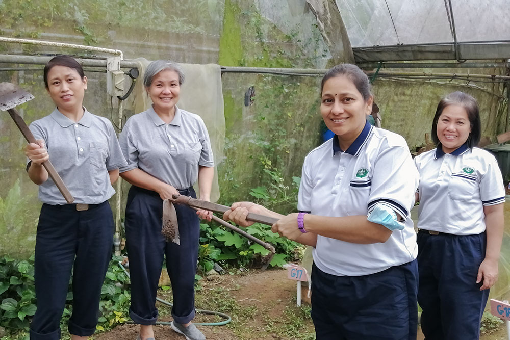 Working on the vegetable garden reminds Teacher Rehka of her childhood. (Photo by Au Foong Yee)